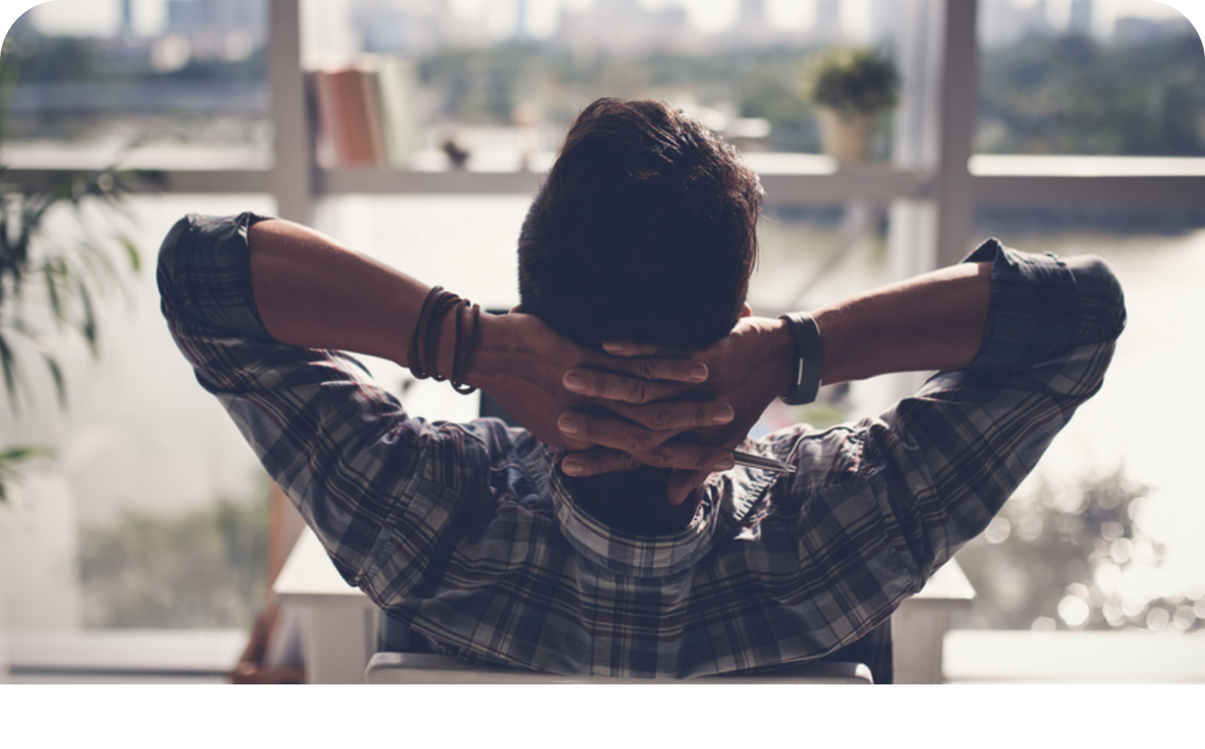 A person leans back at their desk and loosens their shoulders